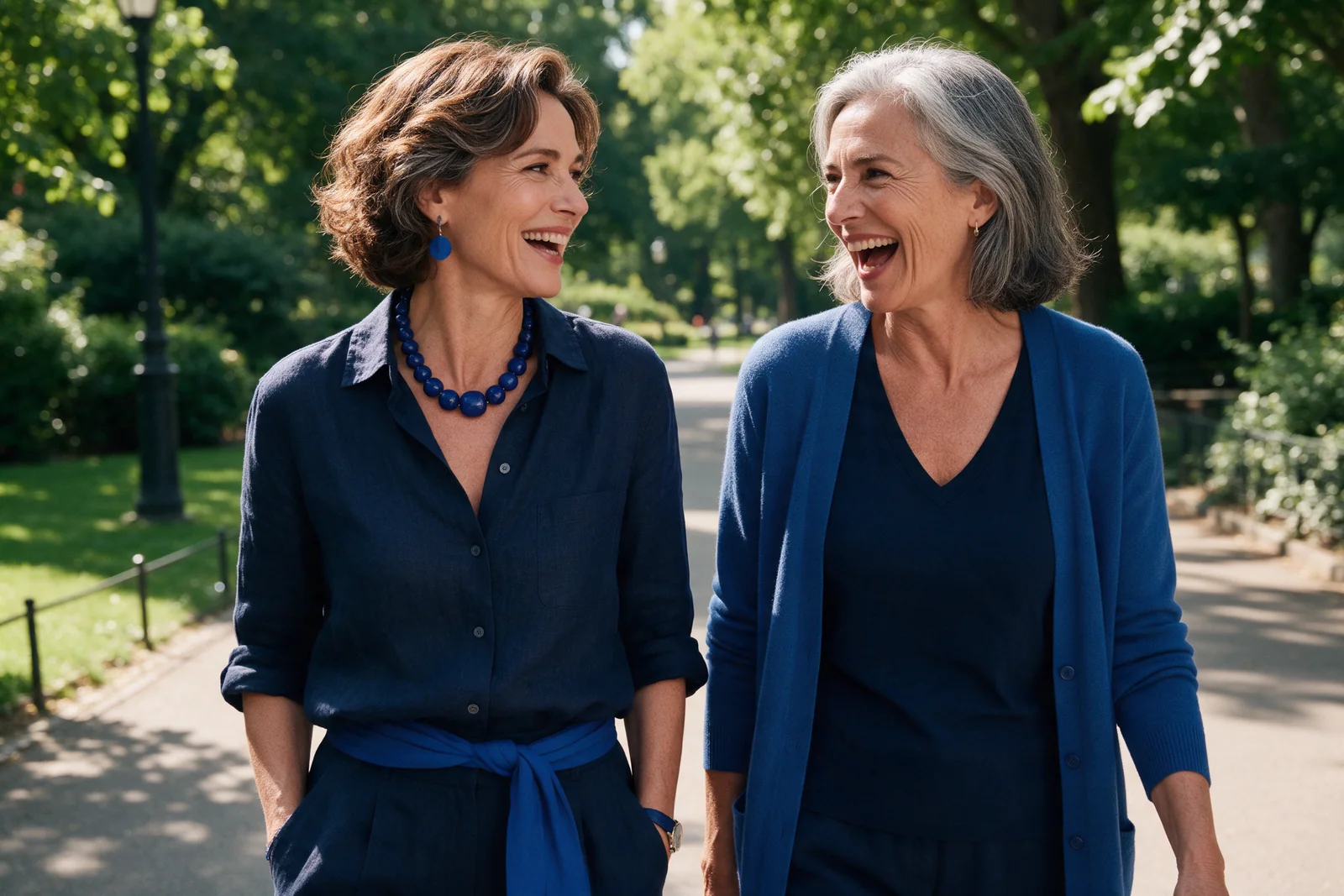 Two joyful women in their fifties enjoying a walk together.